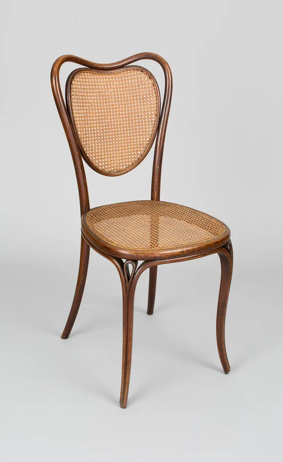 A bentwood side chair with a heart-shaped back, a caned back panel and a caned seat