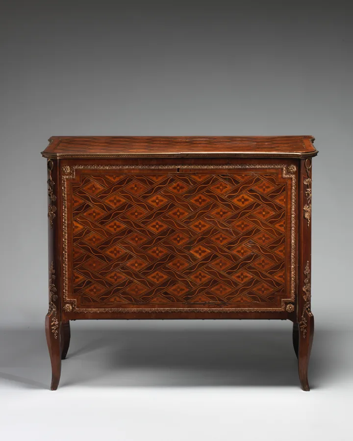 A Swedish marquetry commode with a single parquetry door, gilt-bronze mounts and slender cabriole legs, seen from the front